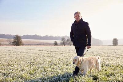 A man walking his dog on a frosty morning